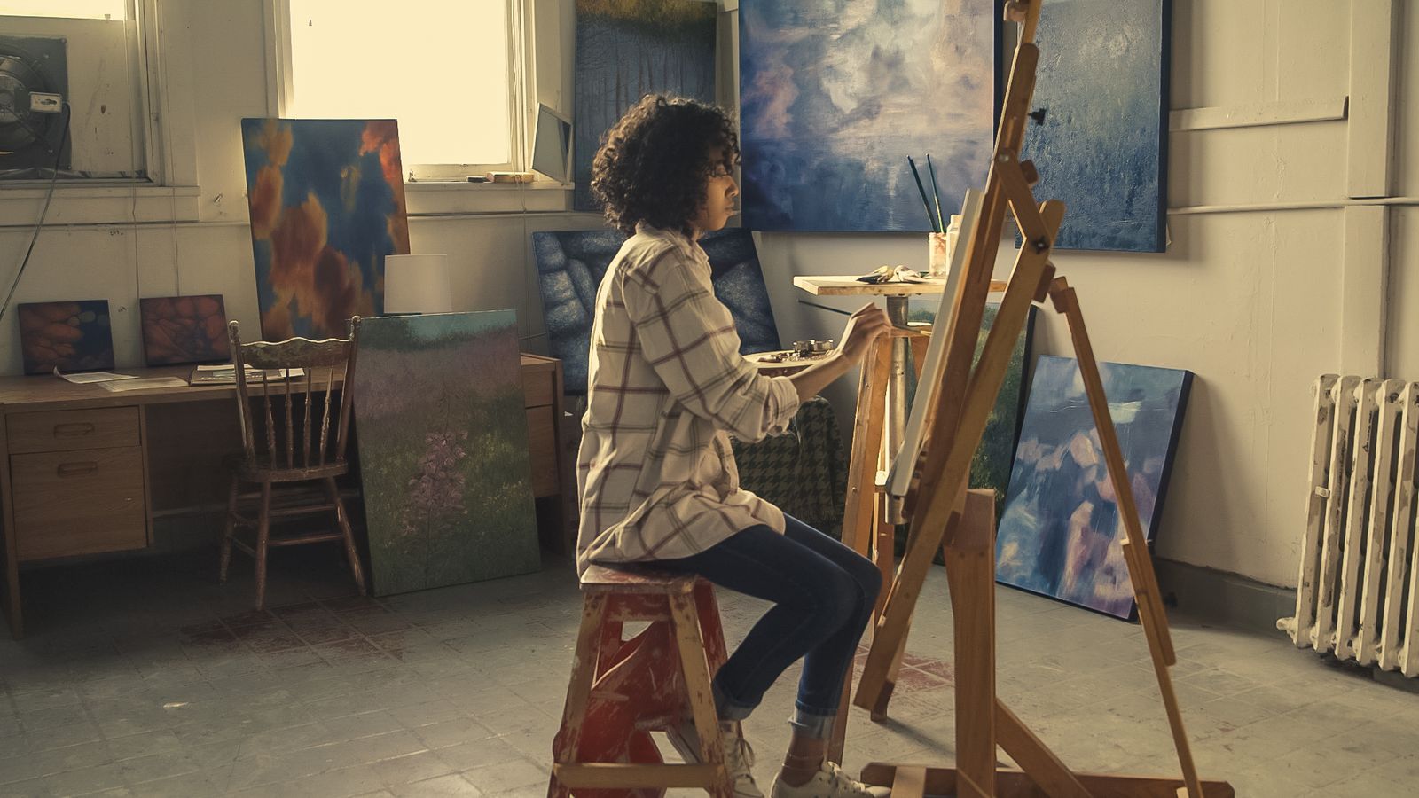 An easel holding a canvas in the studio